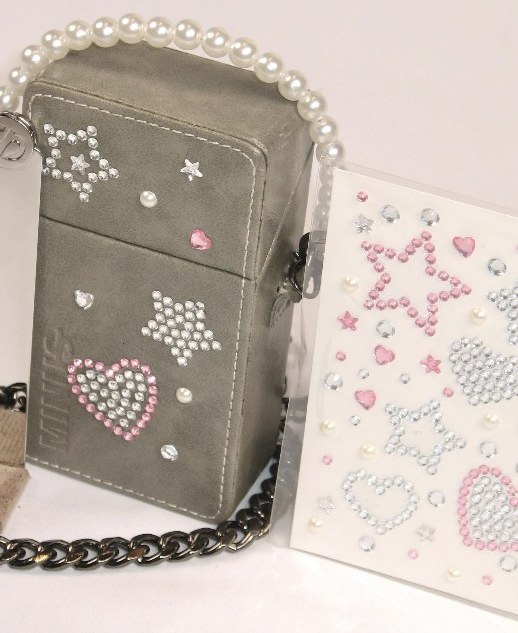 Grey JUST-IN CASE with rhinestone stickers beside the sticker sheet